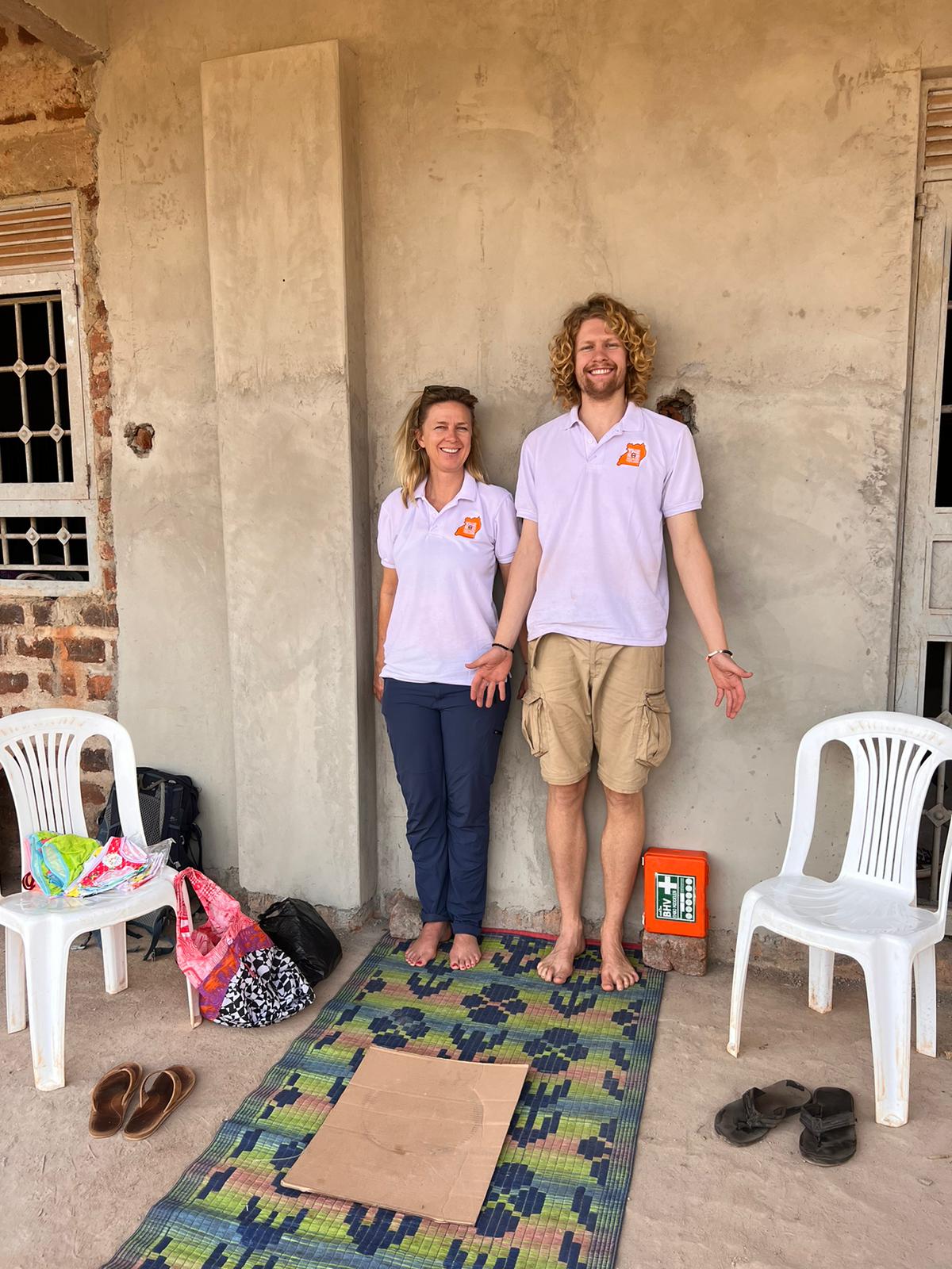 Two researchers posing during fieldwork in Mukono, Uganda, while supporting the development of an anthropometric data collection app
